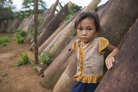 Laotion girl among bomb casings